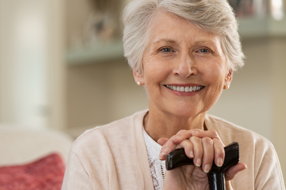 older woman smiling - Taking Care of Your Oral Health Through Your Golden Years